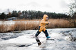 © Cavan Images - boy jumping and playing in the water on an island in Sweden