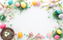 Top Down View Of An Easter Border Frame Of Robin's Eggs And Chocolate Eggs With Copy Space In The Middle