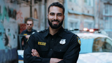 Smiling Young Man Cops Stand Near Patrol Car Look At Camera Enforcement Happy Officer Police Uniform Auto Safety Security Communication Control Policeman Portrait Close Up Slow Motion