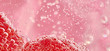 © Will Anderson - Close up of red objects in pink liquid with bubbles