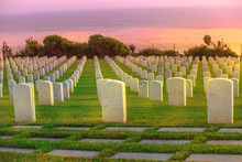 Cemetery Graveyard White Tombstones At Colorful Sunset Sky. American War Cemetery In Point Loma, San Diego, California, United States With Rows Of Gravestones Towards The Ocean.