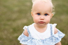 Close-up Photo Of A Little Charming Baby Girl With Beautiful Blue Eyes