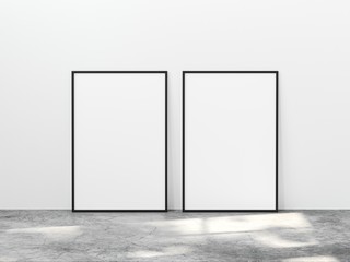 Two vertical black frame mock up on concrete floor with light overlays. Set of two black frame mock up poster. 2 vertical frame 3d illustrations.