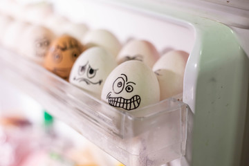 Emotionally eggs in the fridge tray. Real hand-painted eggs