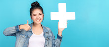 Banner Of Asian Woman Smiling, Showing Plus Or Add Sign And Thumb Up On Blue Background. Cute Asia Girl Wearing Casual Jeans Shirt And Showing Join Sign For Increse And More Benefit Concept