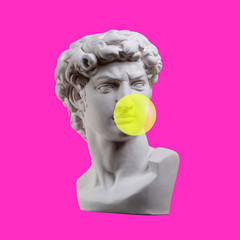 Wall Mural - Statue isolated. Gypsum statue of David's head. Man. Creative. Plaster statue of David's head with bubble gum . Minimal concept art.