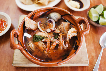 Wall Mural - mexican seafood soup, cazuela de mariscos in Mexico is a bowl of spicy food with shrimps and fish