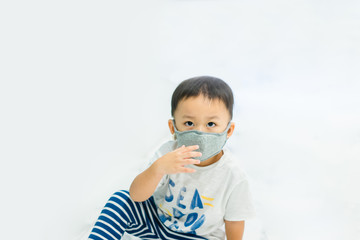 Wall Mural - Coronavirus and Air pollution pm2.5 concept.Little chinese wuhan boy wearing mask for protect pm2.5 in Airport terminal.Toddler boy play in airport.Wuhan coronavirus and epidemic virus symptoms.