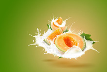 Japanese Melons And Milk Splashing Isolated On Green Background.
