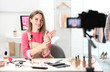© New Africa - Beauty blogger filming make up tutorial at home
