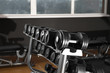 © New Africa - Dumbbells on rack in gym. Modern sport equipment