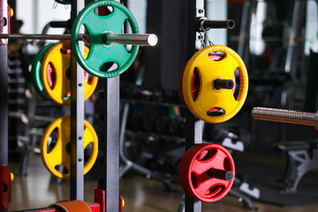 Wall Mural - Barbell weight plates on rack in gym