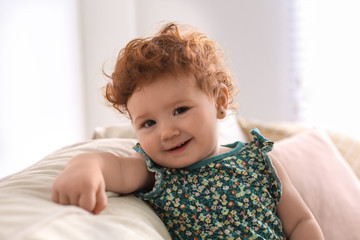 Wall Mural - Portrait of cute little child on sofa at home