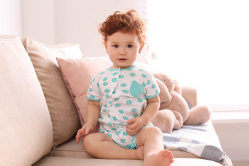 Sticker - Portrait of cute little child on sofa at home