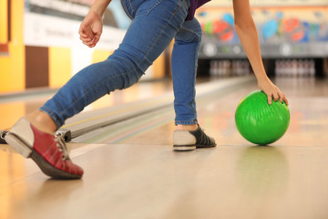 Canvas Print - Child throwing ball in bowling club, closeup