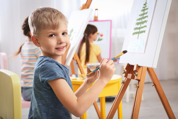 Poster - Cute little child painting during lesson in room