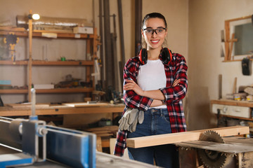 Poster - Professional carpenter near sawmill machine in workshop