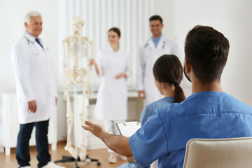 Canvas Print - Medical students having lecture in orthopedics at clinic