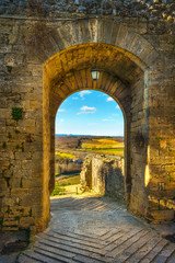 Wall Mural - Monteriggioni medieval fortified village gateway and via francigena route, Siena, Tuscany. Italy