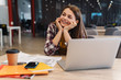 © Drobot Dean - Image of smiling girl doing homework with laptop and exercise books