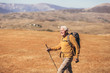 © Mediteraneo - Senior man on hike through beautiful countryside in autumn.