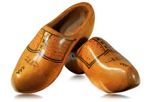 Close-up Of A Pair Of Wooden Clogs Made In Netherlands, Isolated On White Background With Reflections