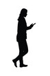 © Flatman vector 24 - Walking woman with cellphone in hand silhouette vector