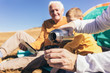 © Mediteraneo - Three generations of family camping together in the autumn.