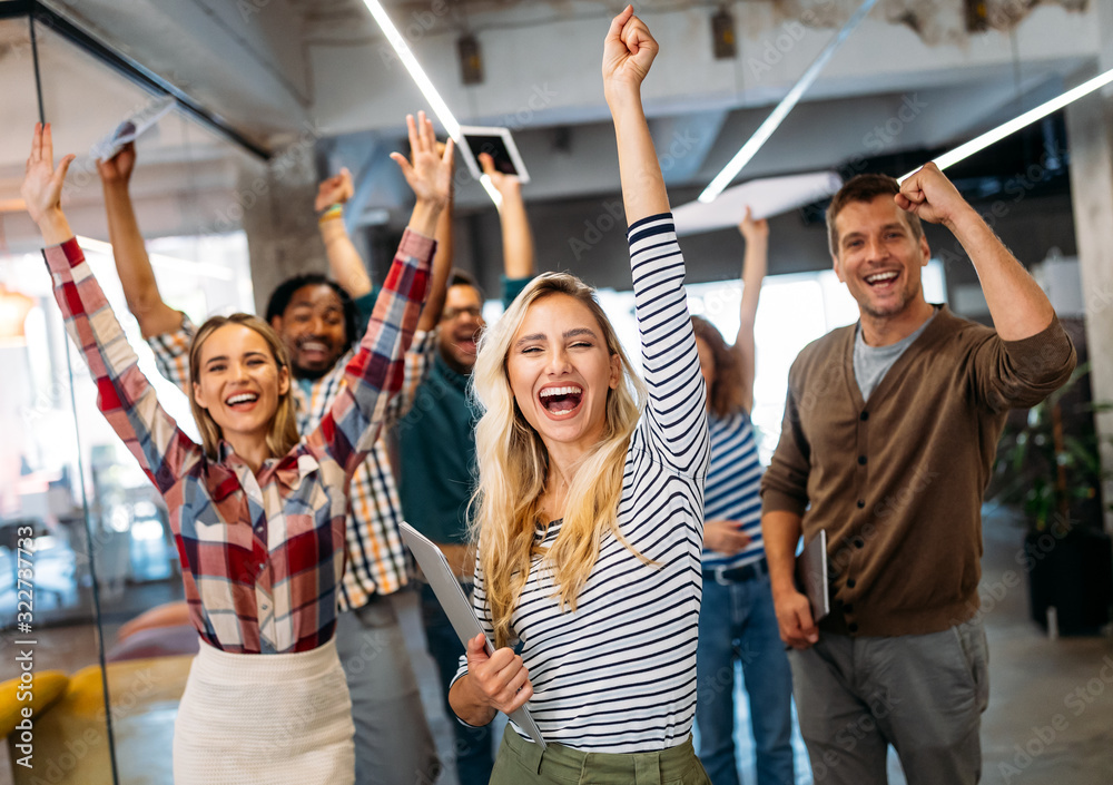 Happy business people celebrating success at company Stock Photo ...