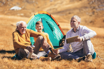 Wall Mural - Three generations of family camping together in the autumn.