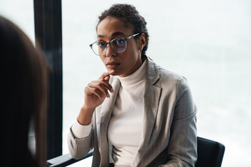 Wall Mural - Portrait of young brunette businesswomen during job interview in office