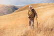 © Mediteraneo - Senior man on hike through beautiful countryside in autumn.