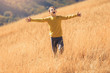 © Mediteraneo - Lovely blonde boy in a yellow sweater having fun on country walk in autumn.