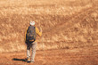 © Mediteraneo - Senior man on hike through beautiful countryside in autumn.