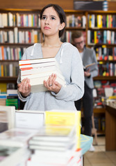 Wall Mural - Portrait of active girl with stack of books