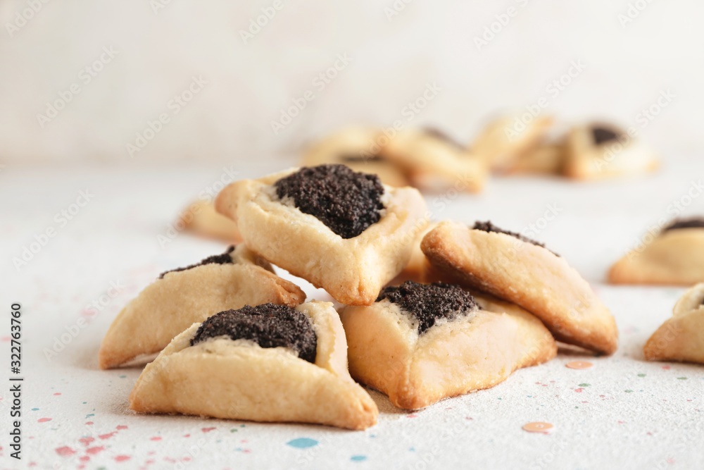 Tasty hamantaschen for Purim holiday on white background