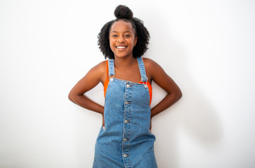 Wall Mural - smiling young african american woman posing by isolated white background