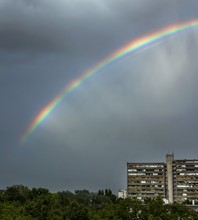 Vertical Shot Of A Beautiful Rainbow In Zagreb, Croatia With A Gray Sky In The Background