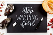 Chalkboard with Stop Wasting Food lettering and rotten fruits