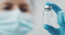 Cropped Shot Of Doctor Holding Transparent Glass Medical Vial In Hand, Focus On Bottle