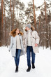 © Елизавета Старкова - Happy lovers a guy and a girl who love each other hug, kiss, laugh, rage and walk in warm jackets in winter against the background of a snowy forest, a friendly family fun walk