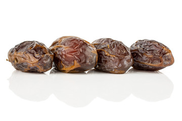 Wall Mural - Group of four whole dry brown date fruit isolated on white background