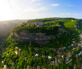 Wall Mural - The city of Chiatura located in the gorge of the Kvirila River, a tributary of the Rioni and on adjacent plateaus. Panorama of the city district on the rock and Upper cable car station Perevisa