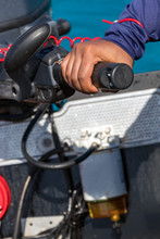 Male Hand Driving A Inflatable Boat Holding The Tiller Of An Outboard Motorboat, Close Up, Outdoors.