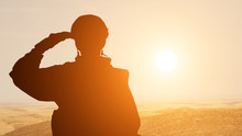Silhouette Of A Solider Saluting Against The Sunrise In The Desert Of The Middle East. Concept - Armed Forces Of UAE, Israel, Egypt