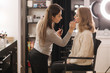 © Aleksandr - Makeup artist work in beauty studio. Woman applying by professional make up master. Beautiful make up artist make a makeup for blond hair model