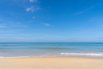 ocean view and white sand beach with blue sky and a tiny wave background