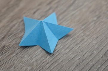Wall Mural - A blue star from paper folded