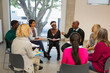 © Chris Ryan/Caia Image - People talking in support group meeting circle