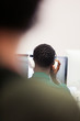 © Sam Edwards/Caia Image - Mature male community college student with headphones at computer